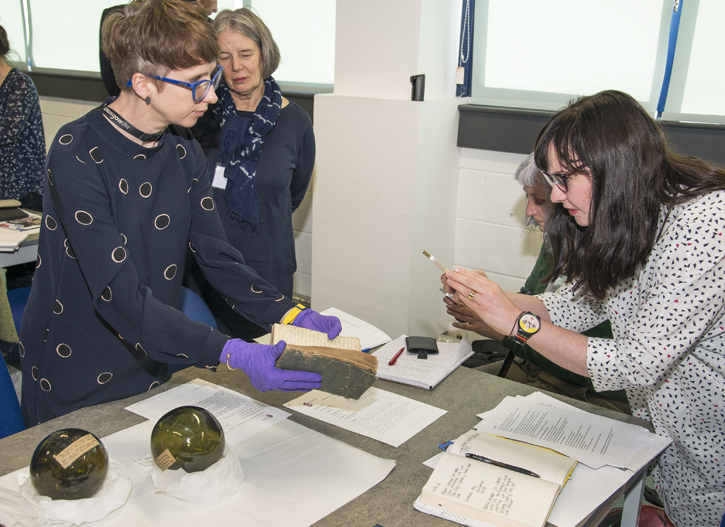 Jo bringing out First World War objects for delegates at creative symposium Doubtful Occasion