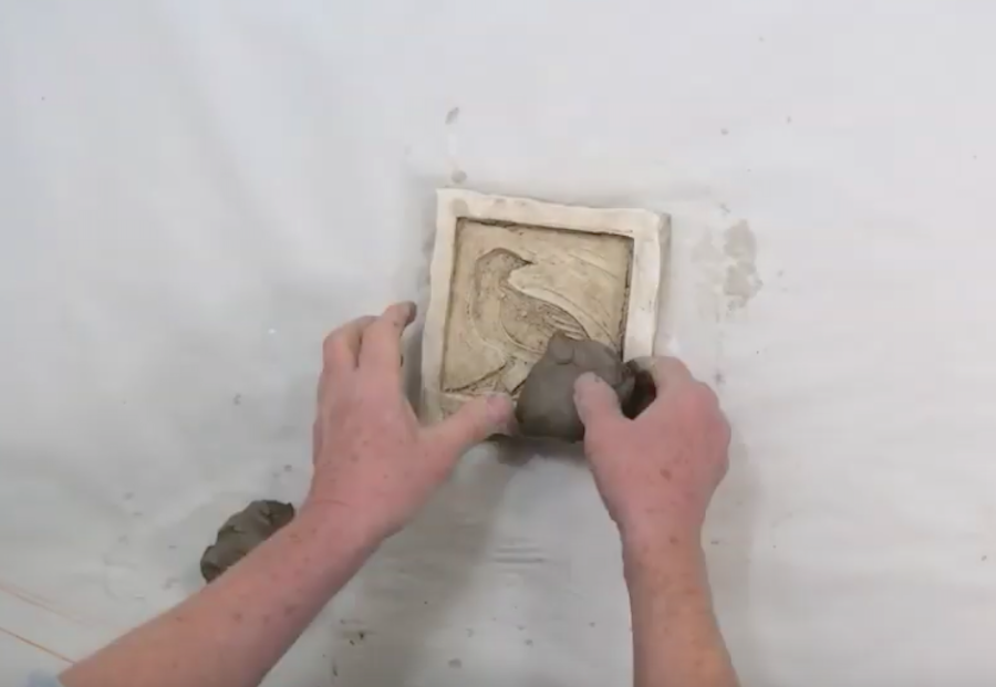 Pressing clay into a mould