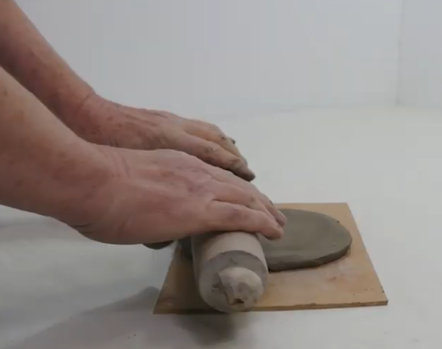 Use a roling pin to roll out clay