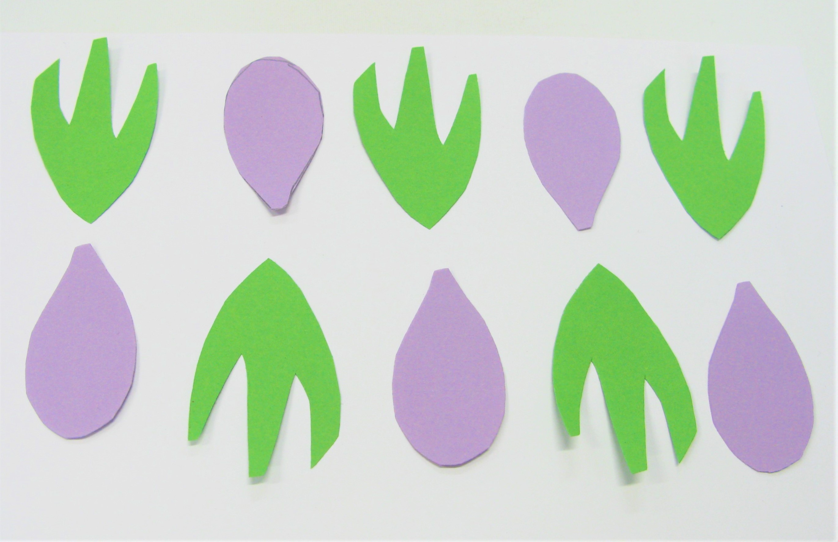 A pattern made from paper shapes inspired by plants