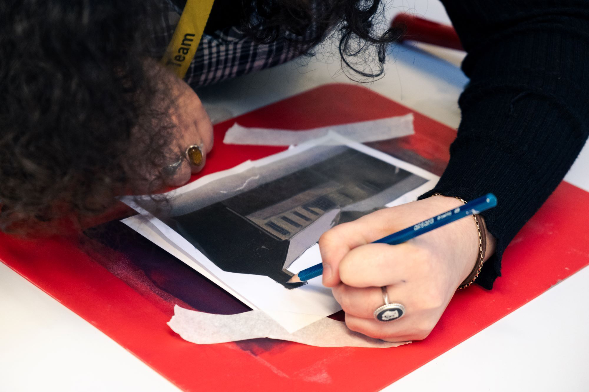 Using a pencil to draw an image over printed template