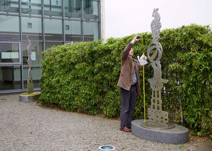 Coordinator Dickon Hall measuring a sculpture at University Hospital, Belfast