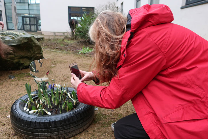 The students at Douglas Academy placed their sculptures next to plants, creating a miniature garden 