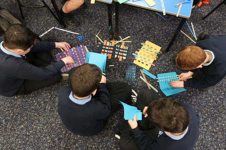 Students weaving paper