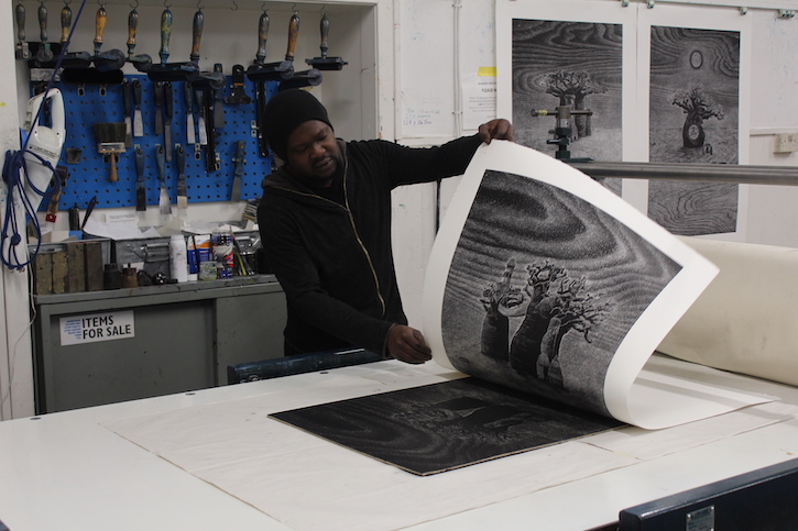 Ade Adesina editioning a print in the workshop