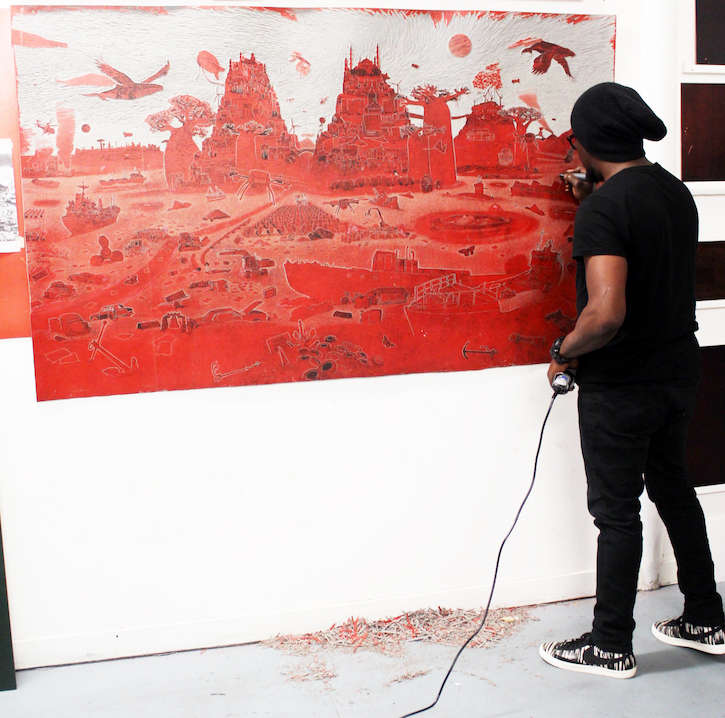 Ade Adesina working on a print in his studio