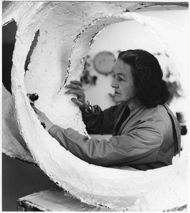 Barbara Hepworth at work on the plaster for 'Oval Form (Trezion)', 1963