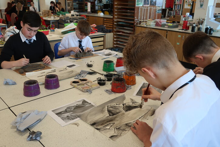 Elgin High School pupils using brush and ink to depict a landscape