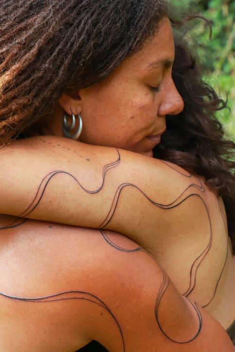2025, photograph and tattoos by Gesiye. Participants: Jamila Versi and Randa Toko; Creative Producer: Hamad Maiye; Cinematographer: Adenike Oke; Colourist: Dedula Kumalo; Music by Avilo Do Espírito Santo
