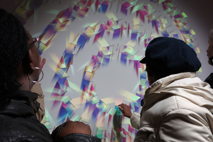 The group explore a luminous artwork 'Opt' by Chris Wood (b.1954), in the chapel