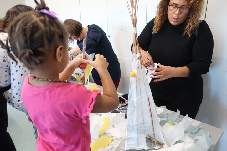 A family enjoys making their sculpture