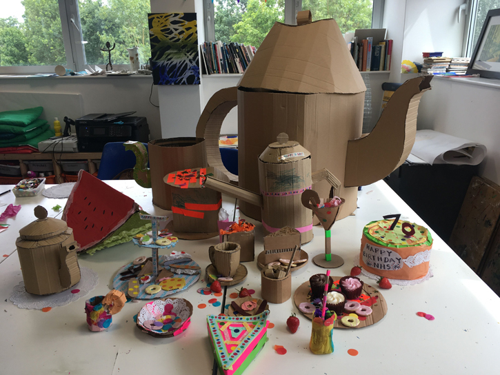 An intricate cardboard tea party installation made by families of NHS staff