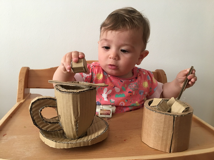 The artist’s daughter enjoys putting sugar cubes in her make-believe cup of tea!