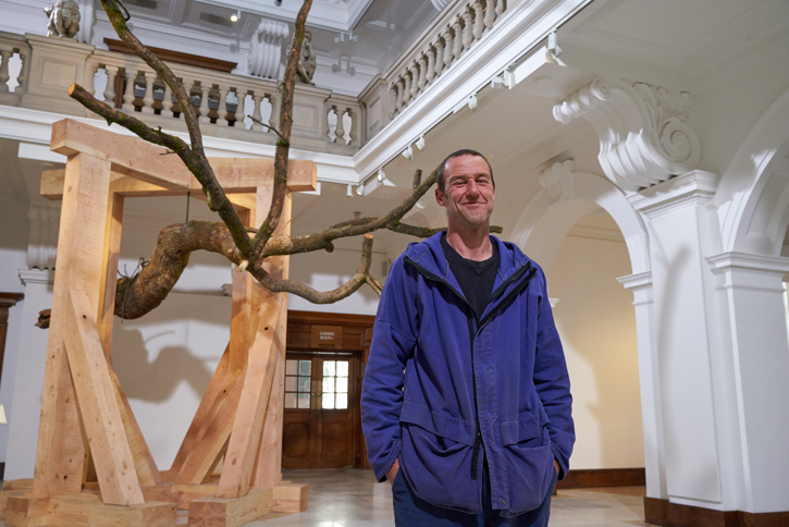 John Merrill with his sculpture