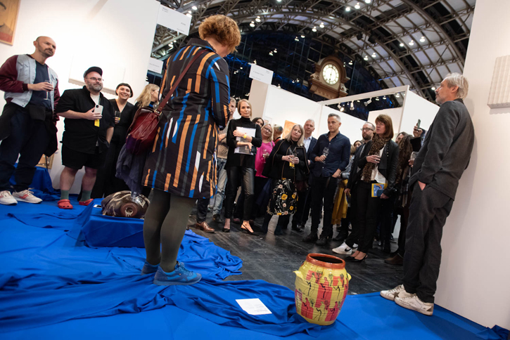 Natasha Howes, Senior Curator (left) and previous Director Alistair Hudson (right) showing TMC patrons Simon Bayliss' 'Jar (Dandelions, after DH Lawrence)', acquired from The Manchester Contemporary in 2022