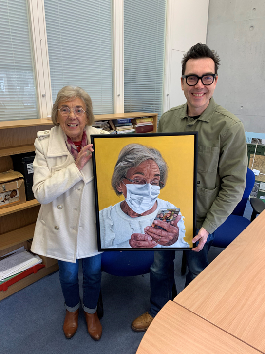 Peter and Joyce Davis handing over the painting 'Stay Safe Mum (elbow elbow)'