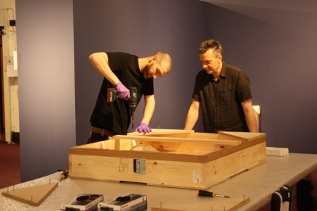 Dave Brunn, Museum Technician, and Peter Ogilvie, Collections Manager, unpacking a transit frame