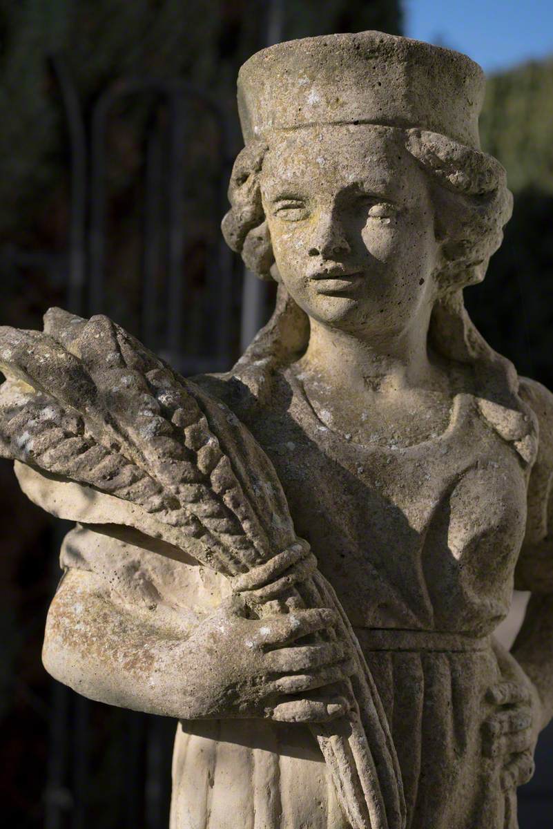 Girl Wearing a Hat Holding a Sheaf of Corn