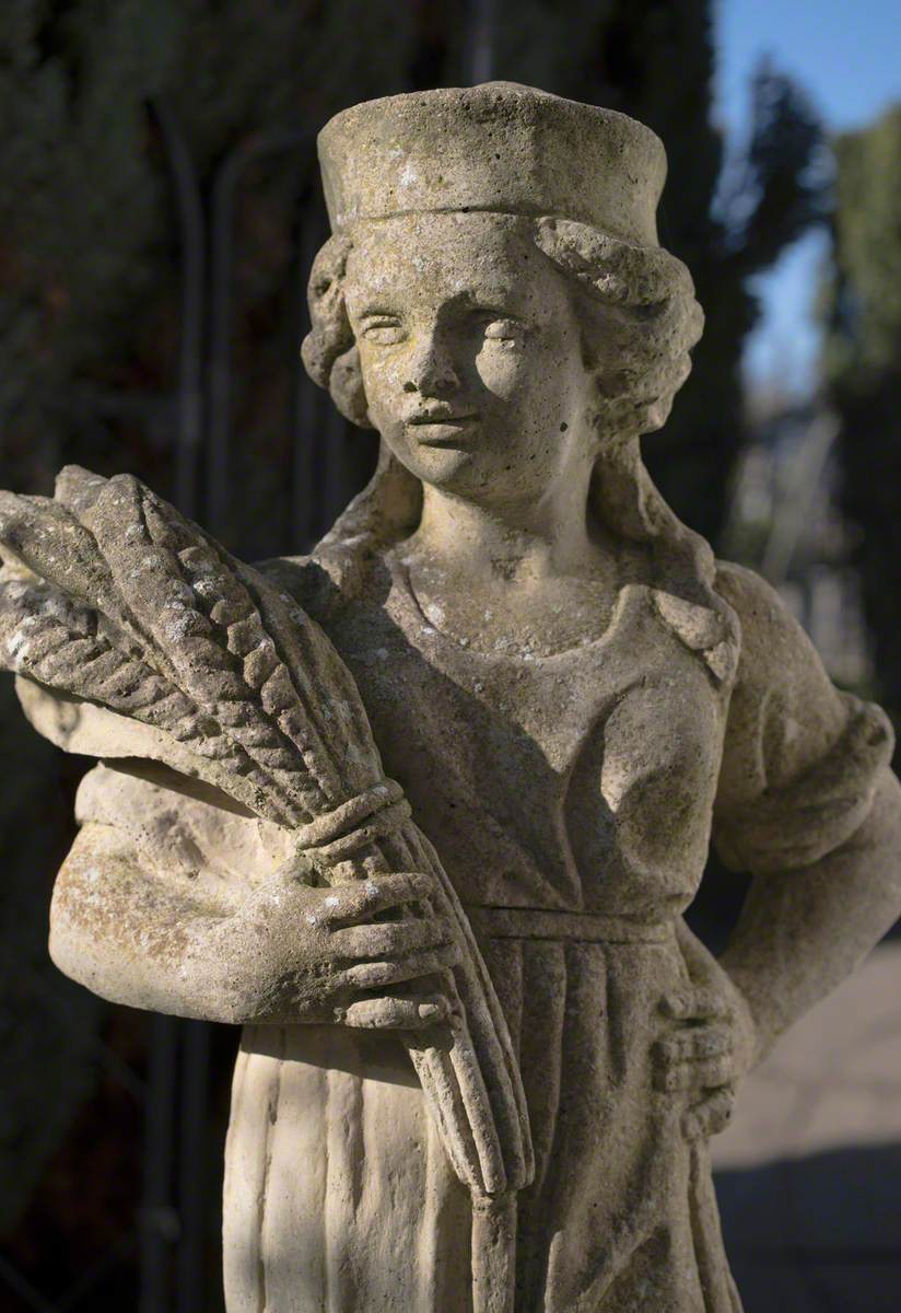 Girl Wearing a Hat Holding a Sheaf of Corn