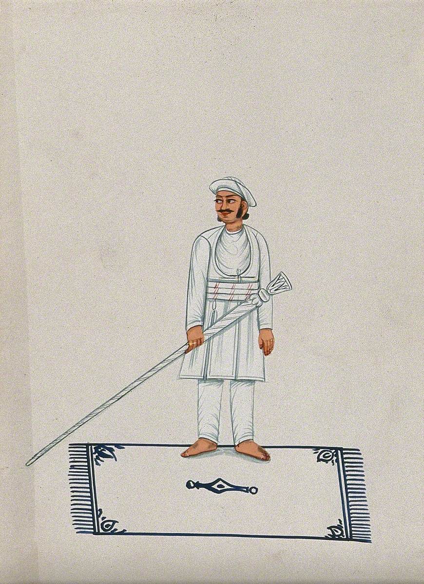 A Man Standing on a Carpet Holding a Long Staff