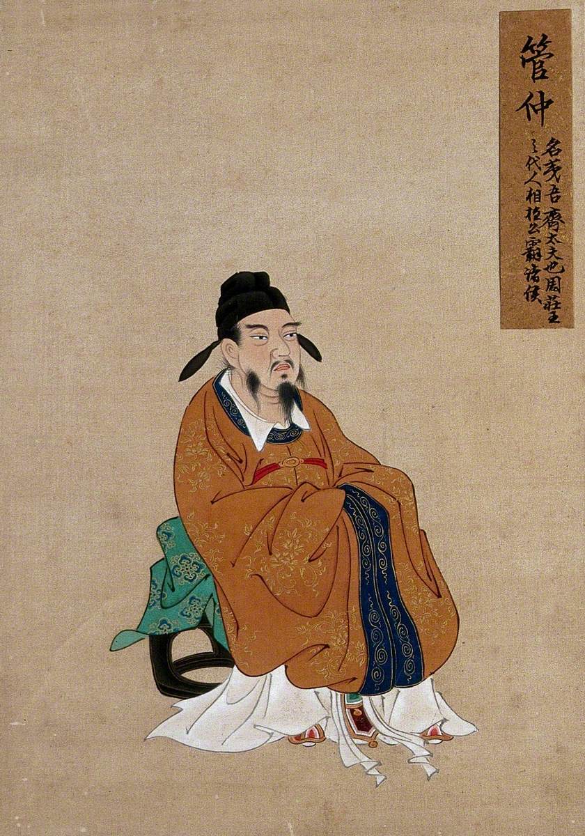 A Seated Chinese Figure with Grey Beard and Black Hat