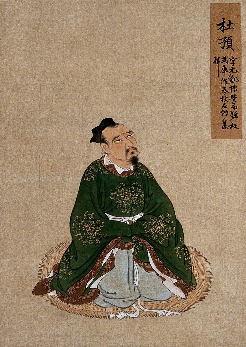 A Seated Chinese Figure in Green Silk with Brown Border