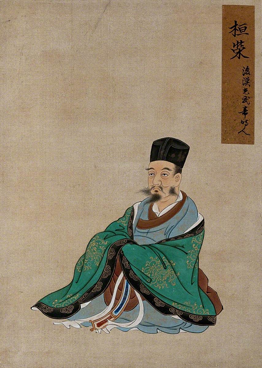 A Seated Chinese Figure Wearing Green Robes with Black Border and Black Hat
