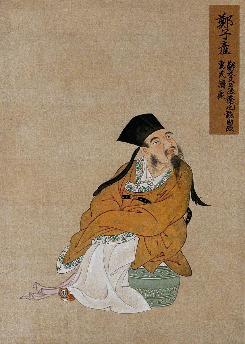 A Seated Chinese Figure Wearing Gold Robes and Black Hat