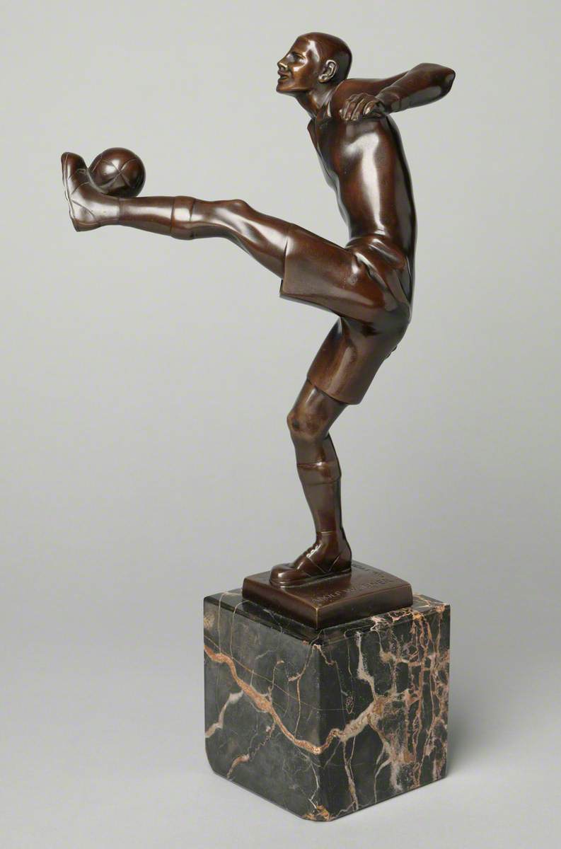 Footballer Kicking a Ball*