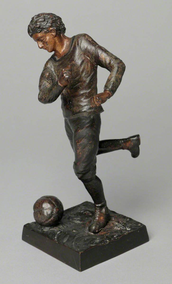 Boy Kicking a Football*