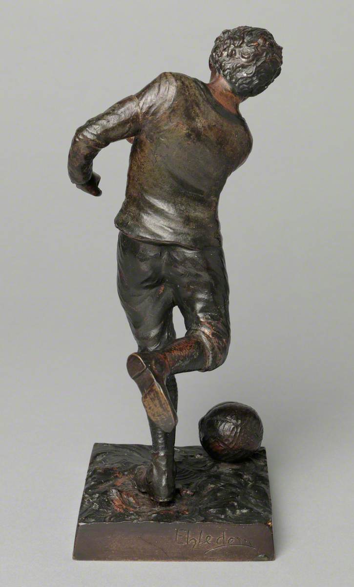 Boy Kicking a Football*