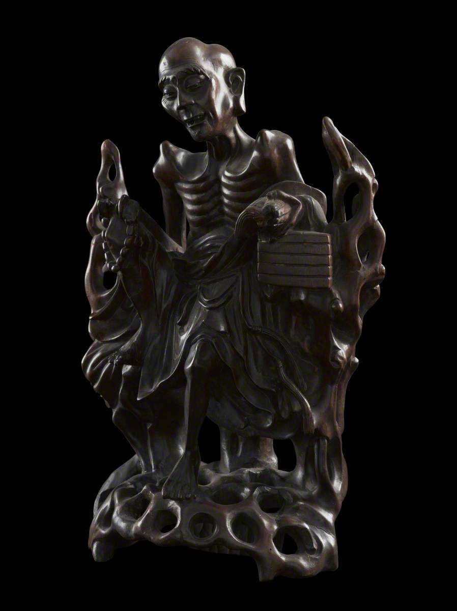 Figure of Moh Chicho reading Buddhist doctrine