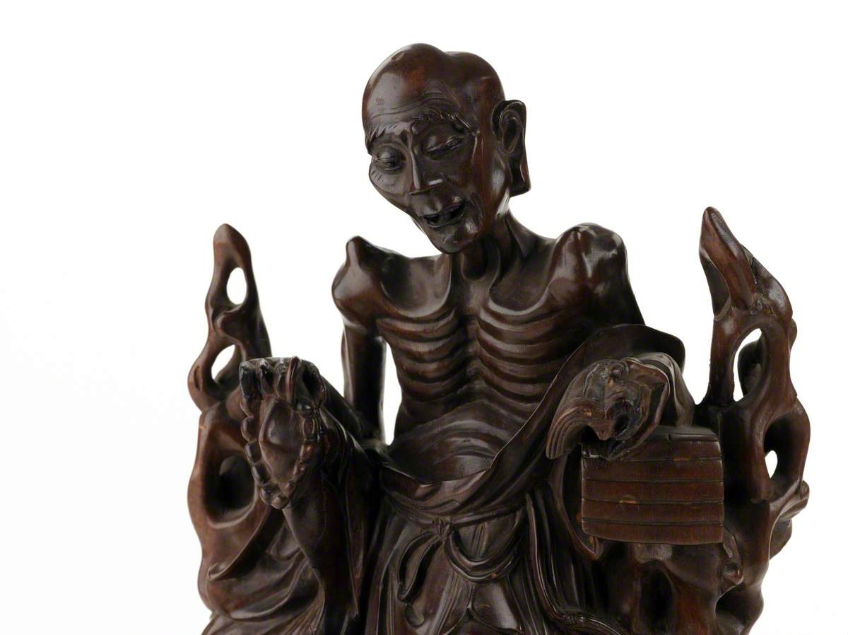 Figure of Moh Chicho reading Buddhist doctrine