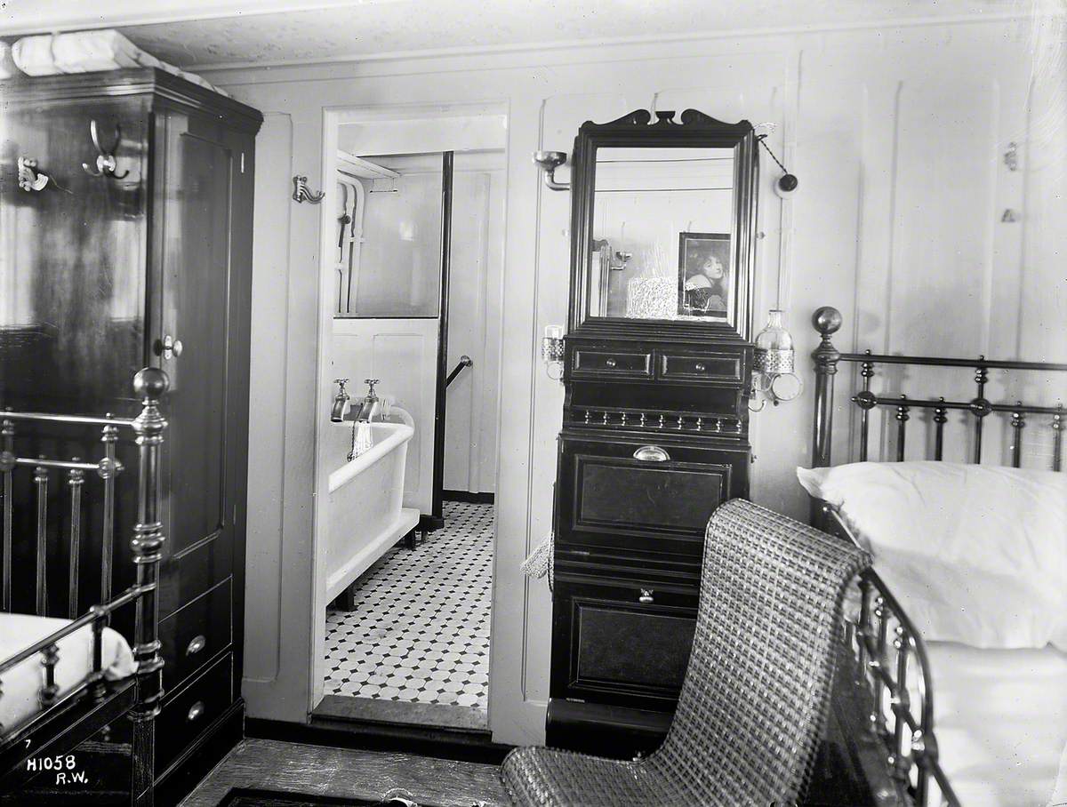 First class state room with open door leading to bathroom