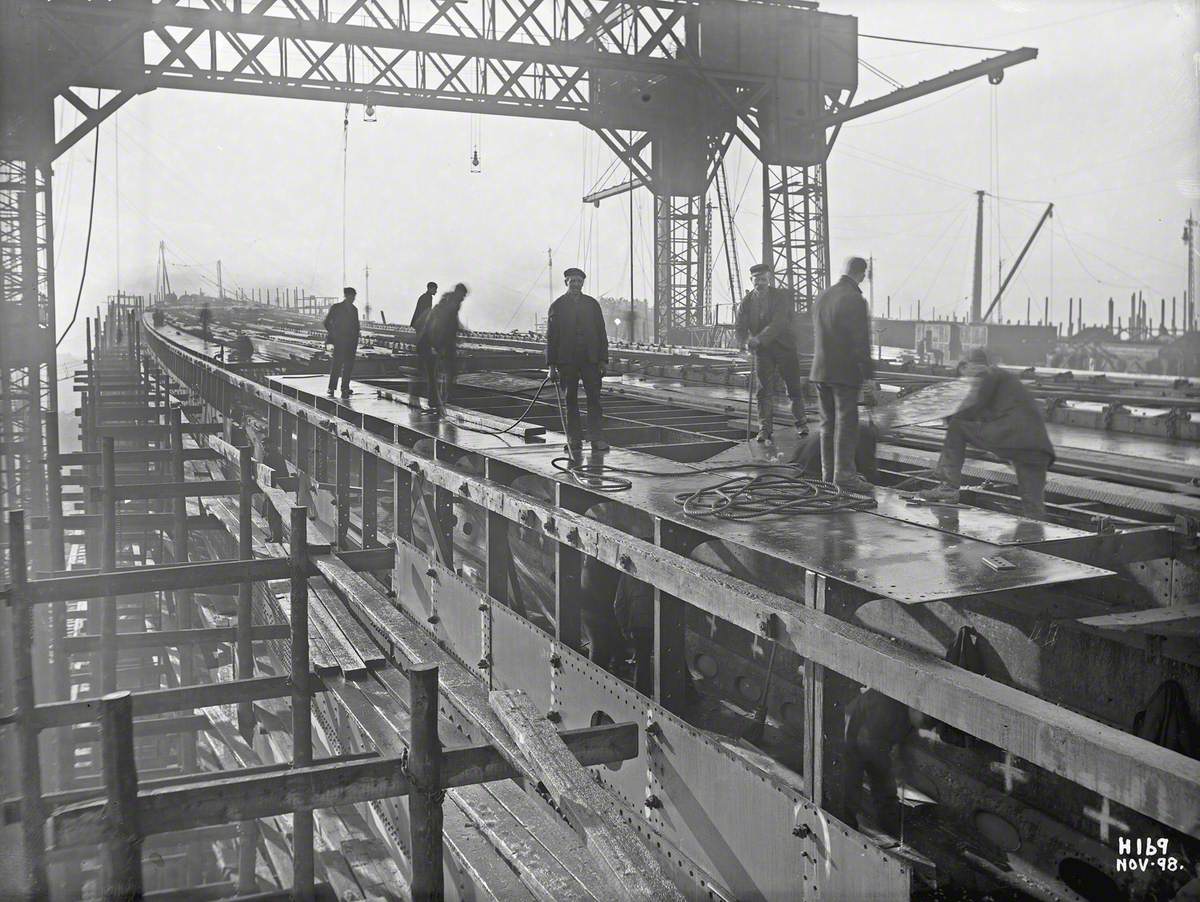 Laying steel deck plating over deckhouses on upper deck