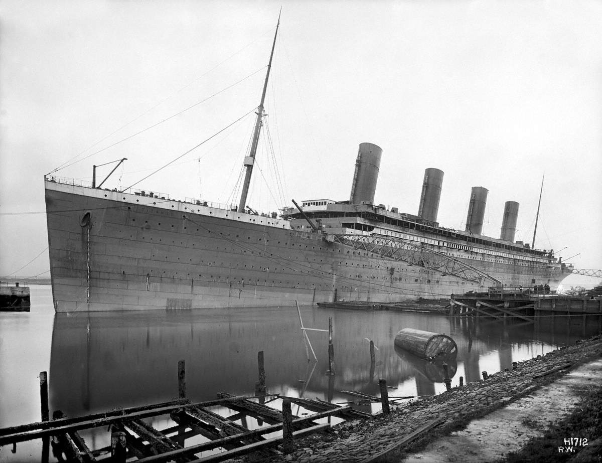 Port bow 3/4 profile at outfitting jetty, with funnels up, but unpainted