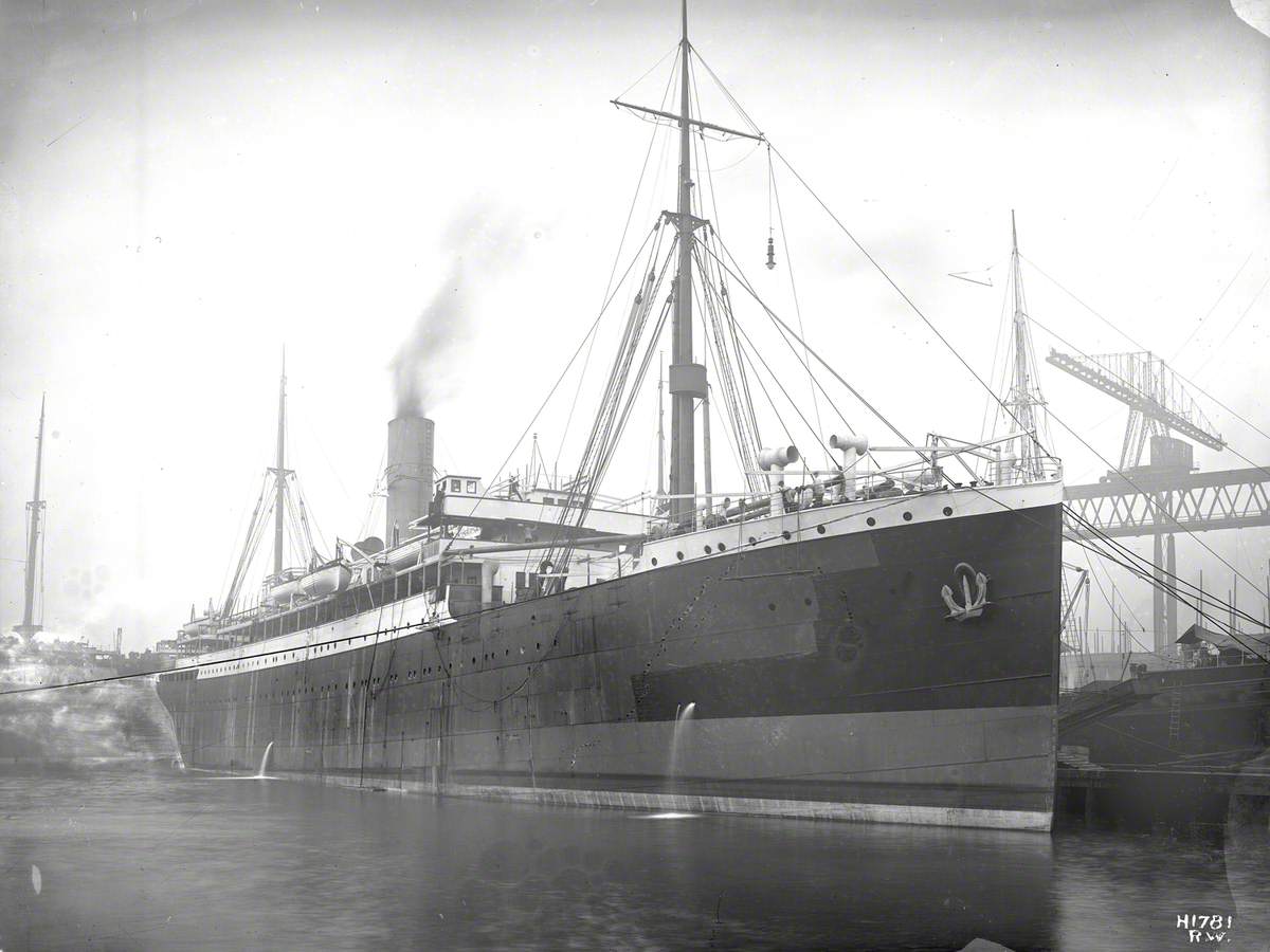 Starboard bow view of almost completed ship alongside outfitting jetty