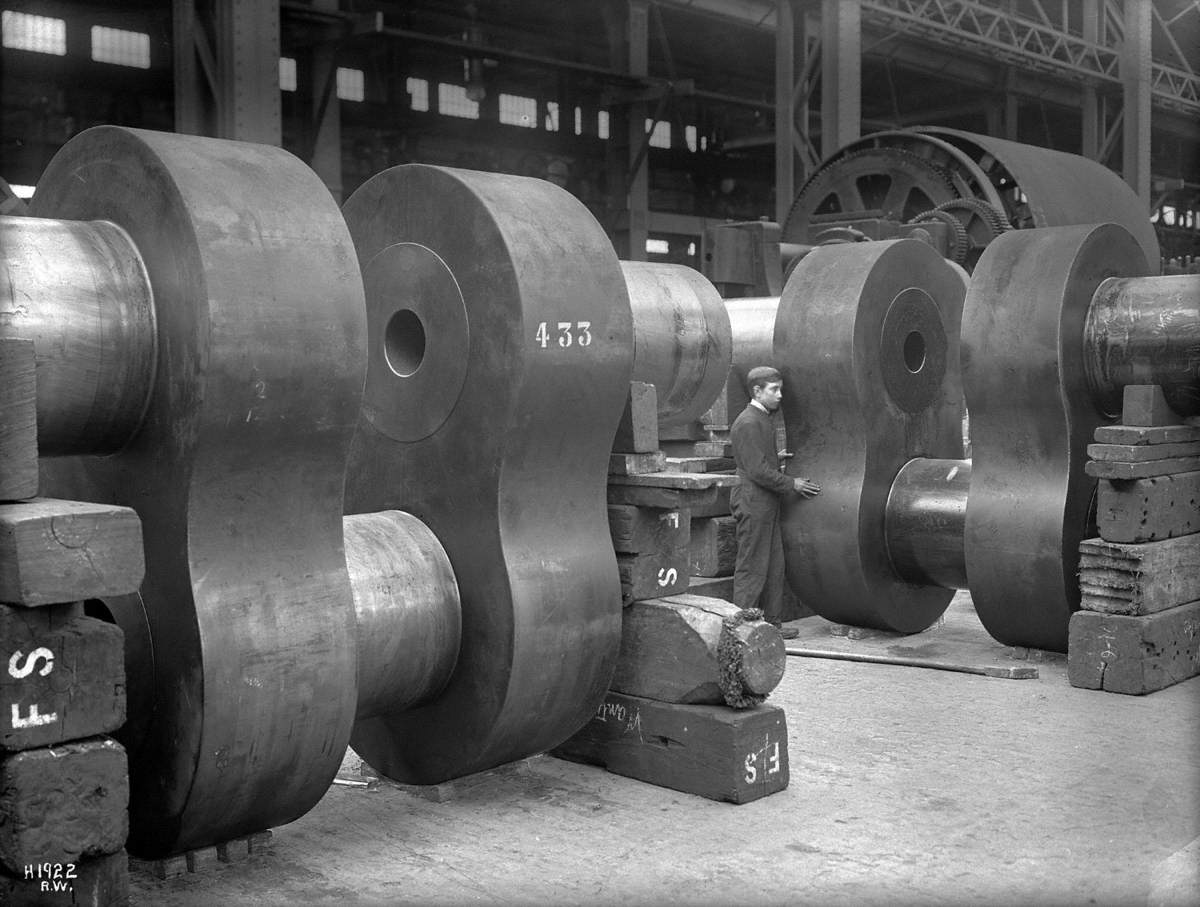 Cranks for reciprocating engine in shop with apprentice to give scale