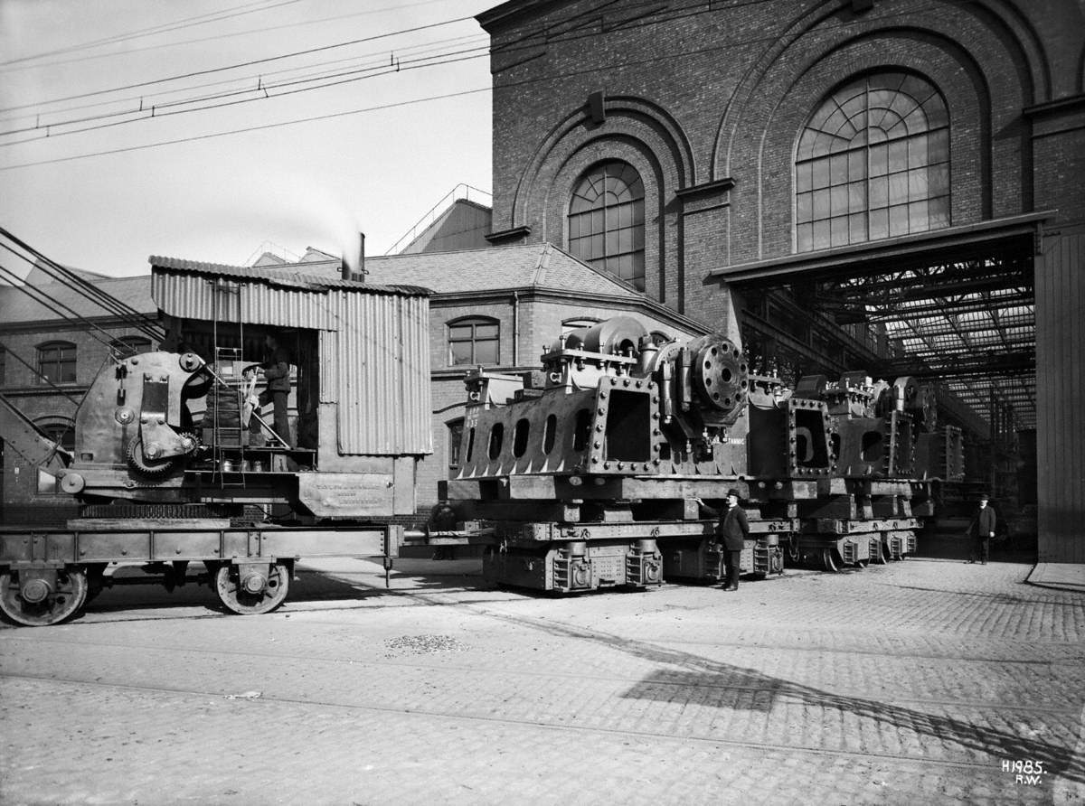 Engine bedplate leaving engine works on railway wagons, being towed by steam engine