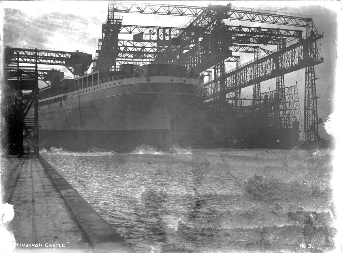 Launch; port stern view of hull entering water