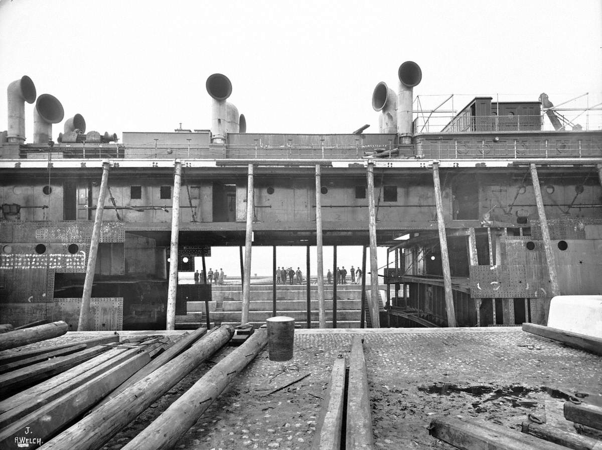 Sequence of views of ship in Alexandra Graving Dock, showing operation to lengthen hull by 54 feet