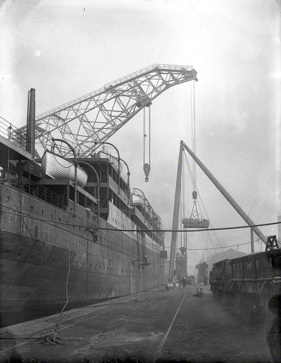 Engine bed and funnel being lifted on board by combination of folating crane and sheer legs