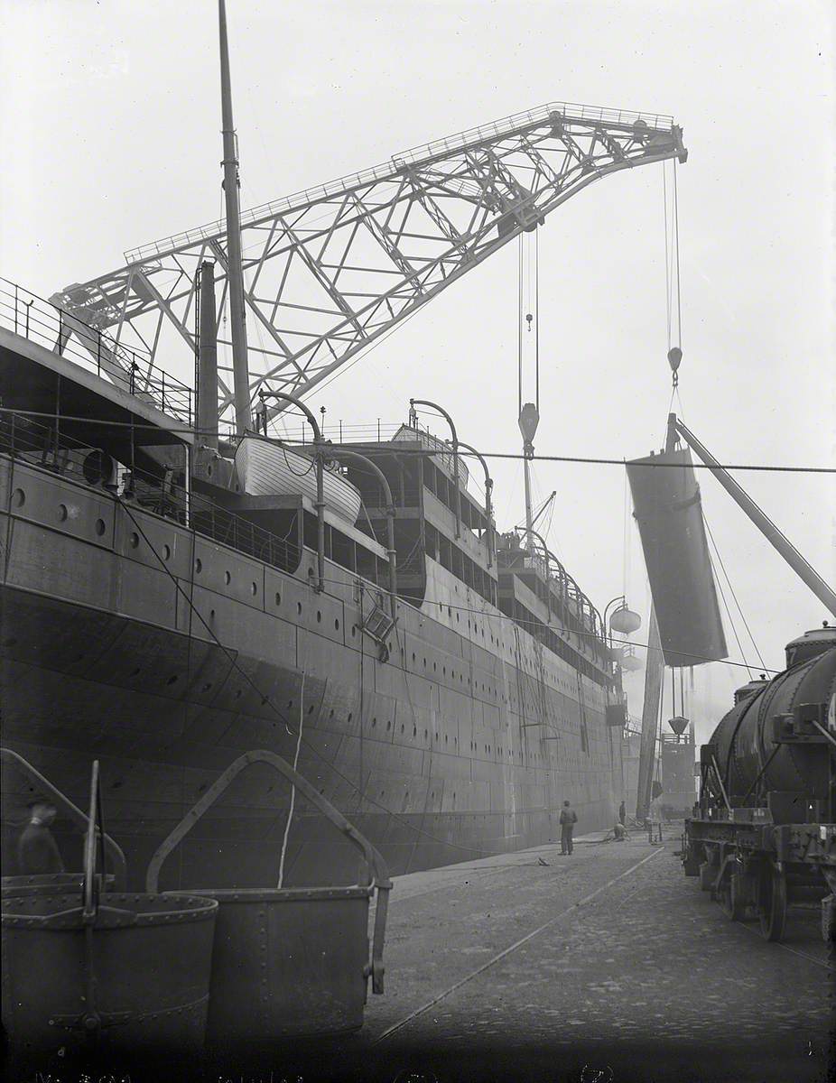 Engine bed and funnel being lifted on board by combination of folating crane and sheer legs