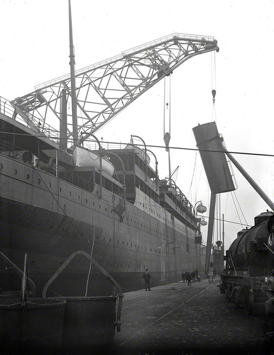 Engine bed and funnel being lifted on board by combination of folating crane and sheer legs