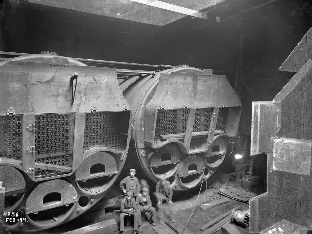 Installation of boilers in stokehold with posed workers