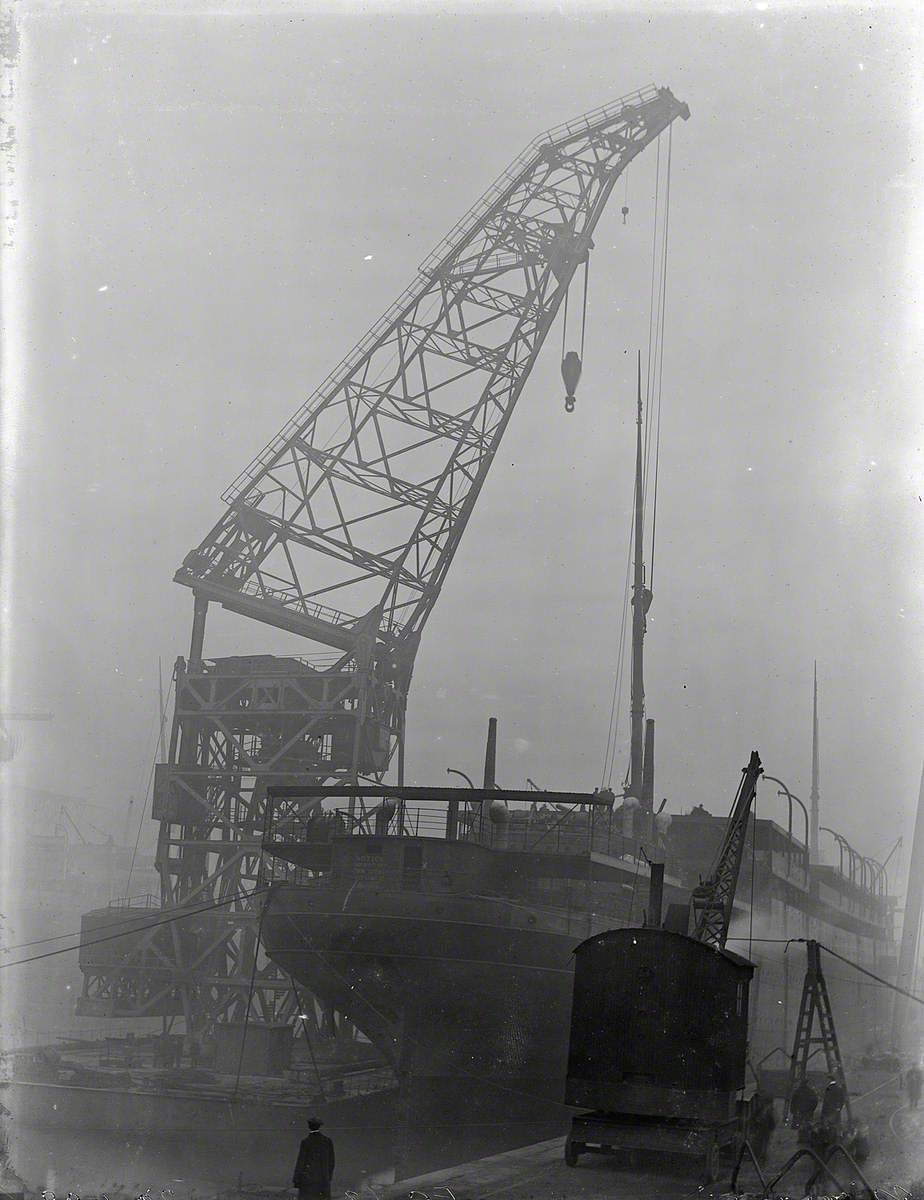 Starboard stern view with floating crane lifting masts on board