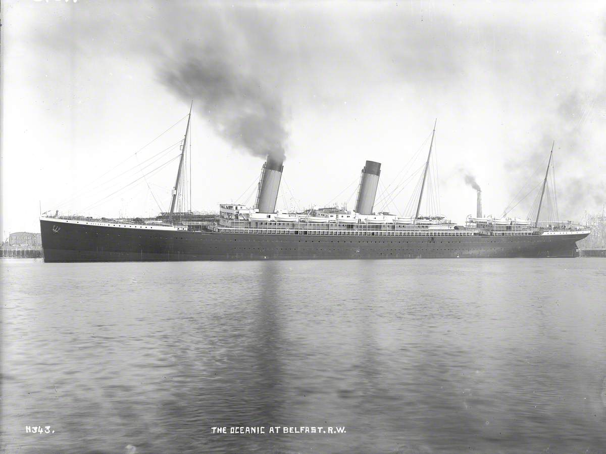 Portside profile of completed ship at outfitting wharf, with list to port