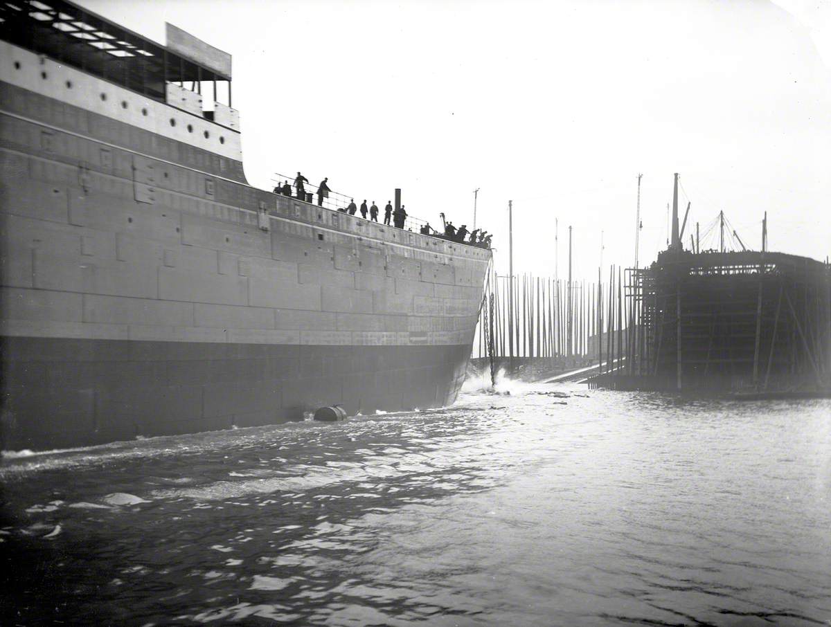 Launch; view of starboard bow entering water with empty slip in background