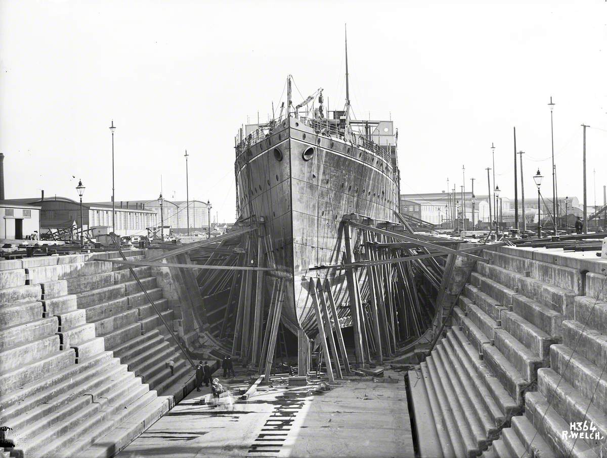 Sequence showing ship in dry dock with shores and cables arranged to support damaged bottom