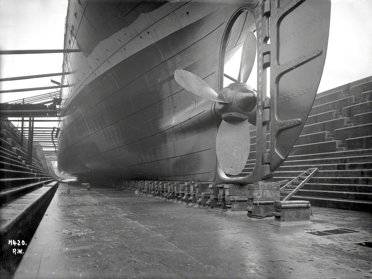 Propeller and underside hull, port view forward from dock floor